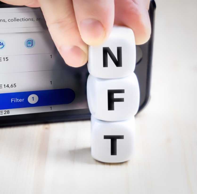 NFT spelled out with dice with letter printed on them.